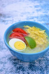 Soto Ayam, traditional Indonesian soup made from broth, chicken, egg, vermicelli and vegetables.