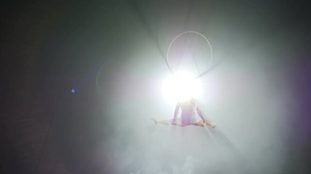 Young girl performs the acrobatic elements in the air ring