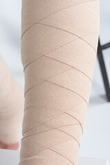 Lymphedema management: Wrapping leg using multilayer bandages to control Lymphedema. Part of...