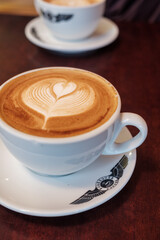 cup of coffee on table with latte art
