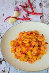 Sambal goreng kentang udang. Fried cubed potato with prawns cooked with coconut milk and spices (Indonesian food)