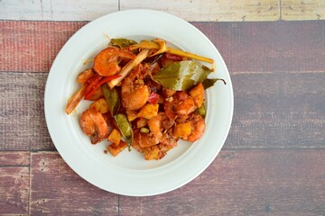 Sambal goreng kentang udang. Fried cubed potato with prawns cooked with coconut milk and spices (Indonesian food)