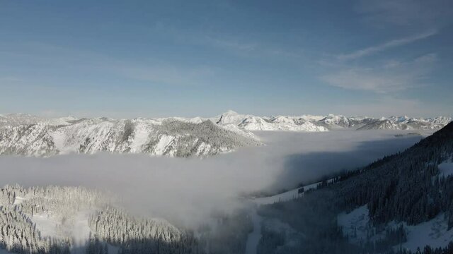 Breathtaking Winter Aerial View of Hazy Fog Clouds in Cascade Mountains Valley