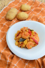 Sambal goreng kentang udang. Fried cubed potato with prawns cooked with coconut milk and spices (Indonesian food)