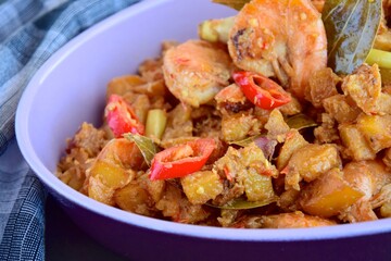 Sambal goreng kentang udang. Fried cubed potato with prawns cooked with coconut milk and spices (Indonesian food)