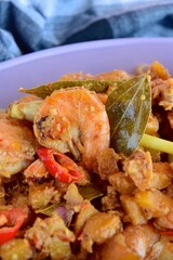 Sambal goreng kentang udang. Fried cubed potato with prawns cooked with coconut milk and spices (Indonesian food)
