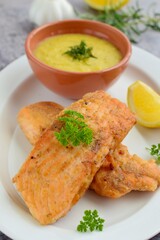 Fried salmon with potato puree with parsley and lemon