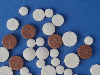 various white tablets on a blue background