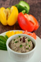 Red mung bean hummus or Adzuki bean dip with bell pepper sticks on wooden background