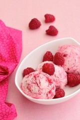 Scoops of raspberry ice cream in a bowl. Summer dessert