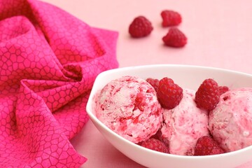 Scoops of raspberry ice cream in a bowl. Summer dessert