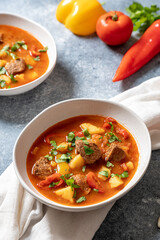 goulash is a traditional Hungarian dish with beef, potatoes, tomatoes and peppers. goulash in white...