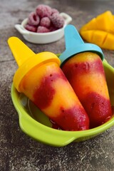 Fresh mango raspberry popsicles. Summer dessert
