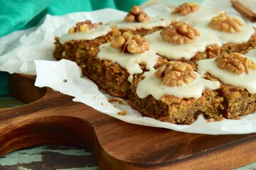 Gluten free carrot quinoa square cake bites topped with sugar glaze and walnut