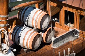 Fototapete Wooden barrels on the deck of a small sailing ship  © Christian Wohlfahrt