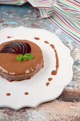 Homemade gluten free vegan beetroot chocolate cake with almond butter topping garnish with hemp seeds, mint leaf and sliced beetroot. 
