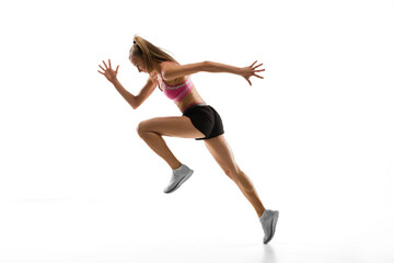 In air. Caucasian professional female athlete, runner training isolated on white studio background. Muscular, sportive woman. Concept of action, motion, youth, healthy lifestyle. Copyspace for ad.