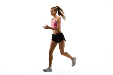 Fototapeta na wymiar Strong. Caucasian professional female athlete, runner training isolated on white studio background. Muscular, sportive woman. Concept of action, motion, youth, healthy lifestyle. Copyspace for ad.