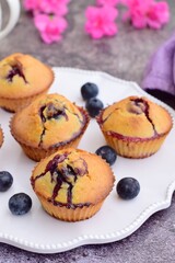 Blueberry muffins on white plate decorated with pink flowers. Selective focus