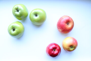 Green and red apples on a white background 