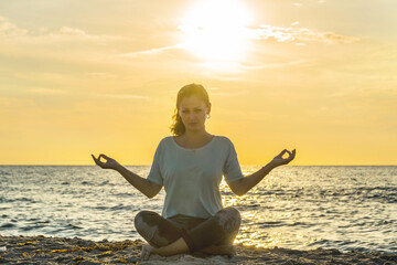 Information overload concept. Woman in the yoga pose sitting on the street surrounded by fast...