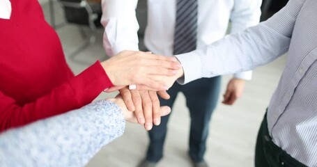 Young business people folding their hands together 4k movie. Successful partnership concept