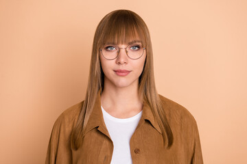 Photo of serious charming pretty nice lady wear glasses weekend isolated on pastel beige color background
