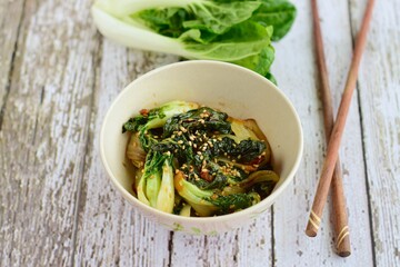 Cooked pak choi with soy sauce and sesame seeds 