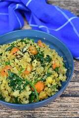 Organic Paleo Cauliflower Fried Rice with vegetables, Herbs and Spices. On wooden background