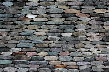 Grunge multicolored natural stones wall. Horizontal image background