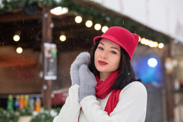 Pleased brunette lady wears knitted cap and scarf