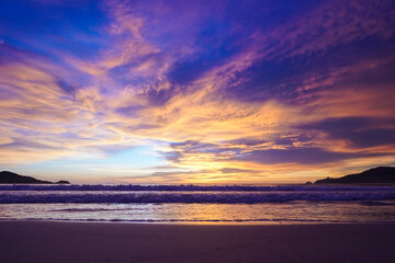 Fototapeta na wymiar Bright scenic sunset on the beach in a blue orange shade