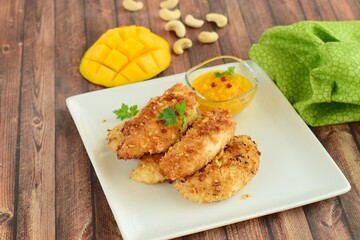 Chicken fingers breaded with cashew and coconut flakes. Served with mango red pepper dip