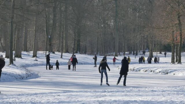 Netherlands - 12 februari 2021, Hilversum: People skating on ice in Groeneveld national park