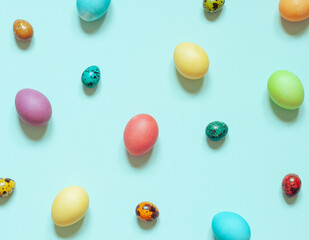 Colorful painted Easter eggs on the blue background. Top view