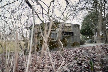 A brutalist cold gritty concrete world war two, ww2, pillbox war bunker defence fortress in a dirty...