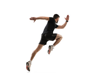 Fototapeta na wymiar In jump. Caucasian professional sportsman training isolated on white studio background. Muscular, sportive man practicing. Copyspace. Concept of action, motion, youth, healthy lifestyle.
