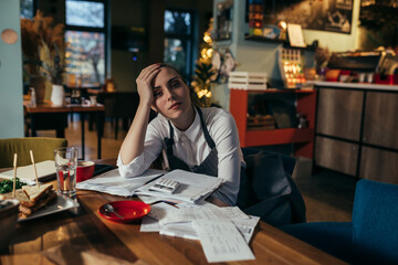 manager dealing with finances in her restaurant