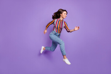Fototapeta na wymiar Full length body size photo of pretty girl jumping up running fast on sale isolated on vivid purple color background