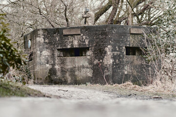 A brutalist cold gritty concrete world war two, ww2, pillbox war bunker defence fortress in a dirty...