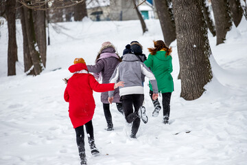 teens running through the snow