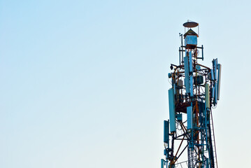 Tower with antennas on a background of blue sky. Television and radio antennas on the iron tower.