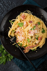 Pasta carbonara with bacon and parmesan on a plate