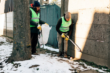 retired people collecting garbage in the street. volunteer service and sustainability lifestyle concept.