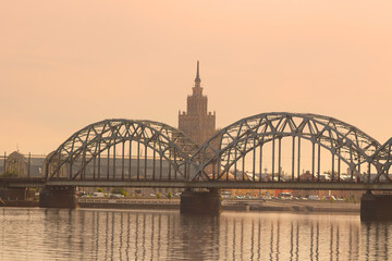 Naklejka premium View of Latvian Academy of Sciences, Railway bridge and Daugava river on the sunrise in Riga, Latvia