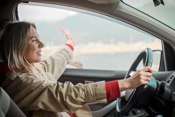 Young stylish woman driving car. Travel, Holidays, Journey, Trip, Lifestyle concept. Health care, authenticity, sense of balance and calmness.