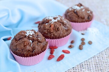 Chocolate muffins with coconut flakes, goji berry and chocolate chips