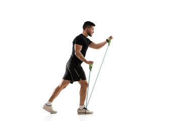 Stretching. Caucasian professional sportsman training isolated on white studio background....