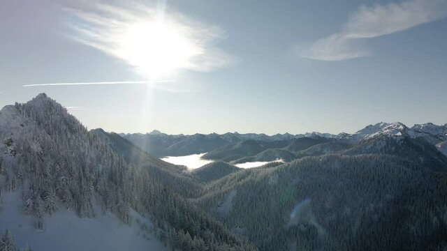Hazy Blue Silhouette of Mountain Peaks Aerial on Sunny Winter Day