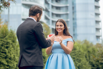 Man giving gift and enthusiastic joyful woman